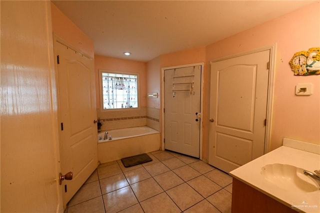 bathroom featuring tile patterned floors, vanity, and a bath