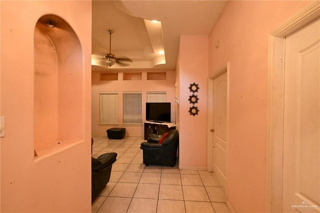 interior space featuring a tray ceiling and light tile patterned floors