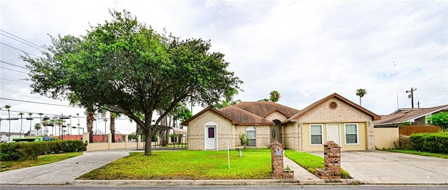 ranch-style home featuring a front yard