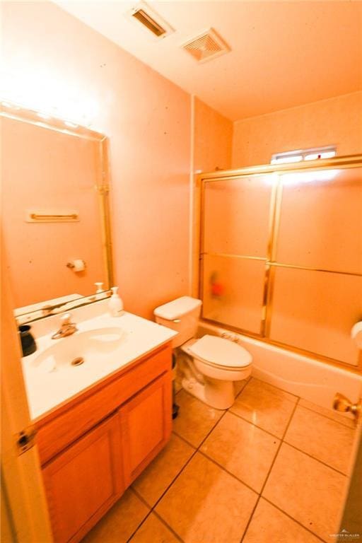 full bathroom with tile patterned floors, vanity, toilet, and combined bath / shower with glass door