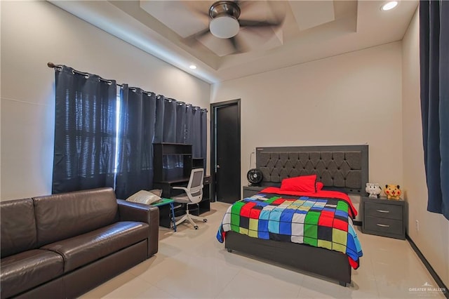 bedroom featuring a raised ceiling and ceiling fan