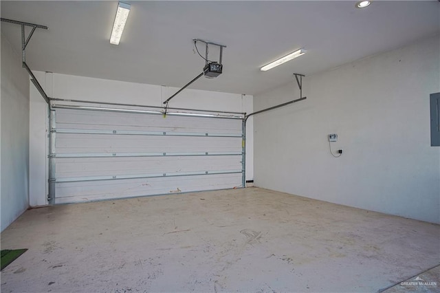 garage featuring a garage door opener and electric panel