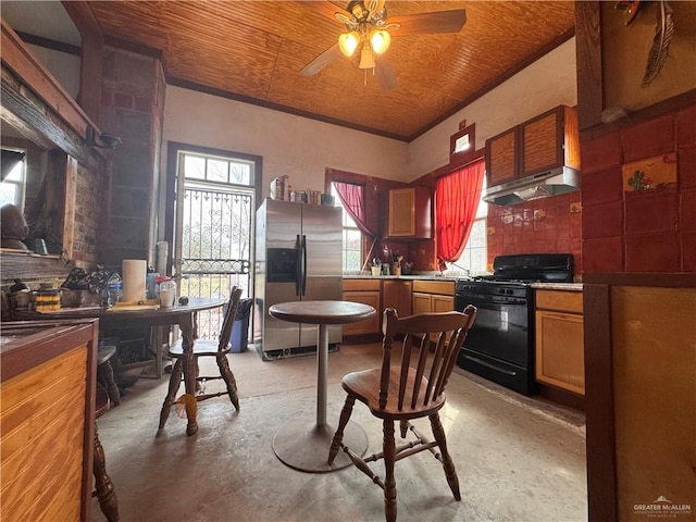 kitchen featuring black range with gas cooktop, tasteful backsplash, ceiling fan, and stainless steel refrigerator with ice dispenser