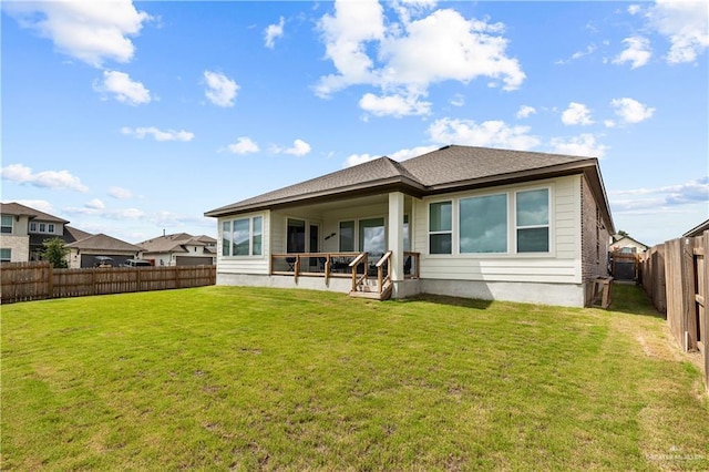 back of house featuring a patio area and a lawn