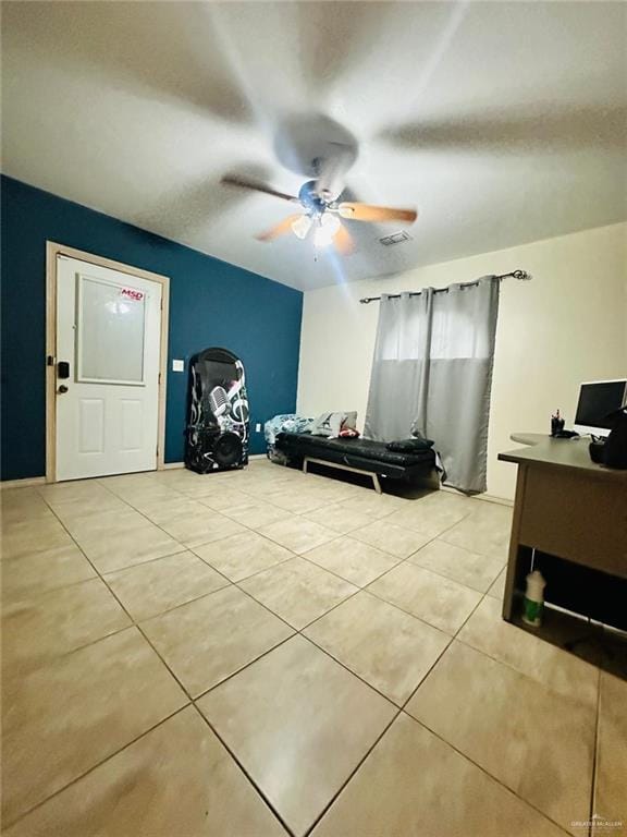 tiled bedroom with ceiling fan