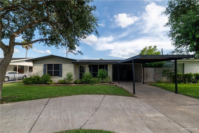 210 E Hurst St E, Harlingen, TX 78550 - view of front of property featuring an attached carport and concrete driveway