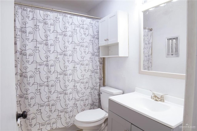 210 E Hurst St E, Harlingen, TX 78550 - bathroom with toilet, vanity, and a shower with curtain
