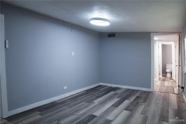 210 E Hurst St E, Harlingen, TX 78550 - empty room with dark wood finished floors and baseboards