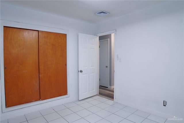210 E Hurst St E, Harlingen, TX 78550 - unfurnished bedroom featuring a closet and light tile patterned floors