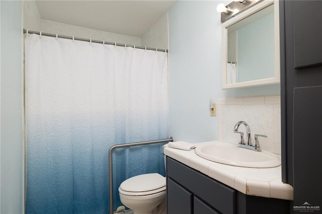 full bath featuring tasteful backsplash, vanity, and toilet
