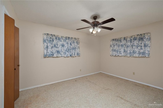 spare room with baseboards, a ceiling fan, and carpet