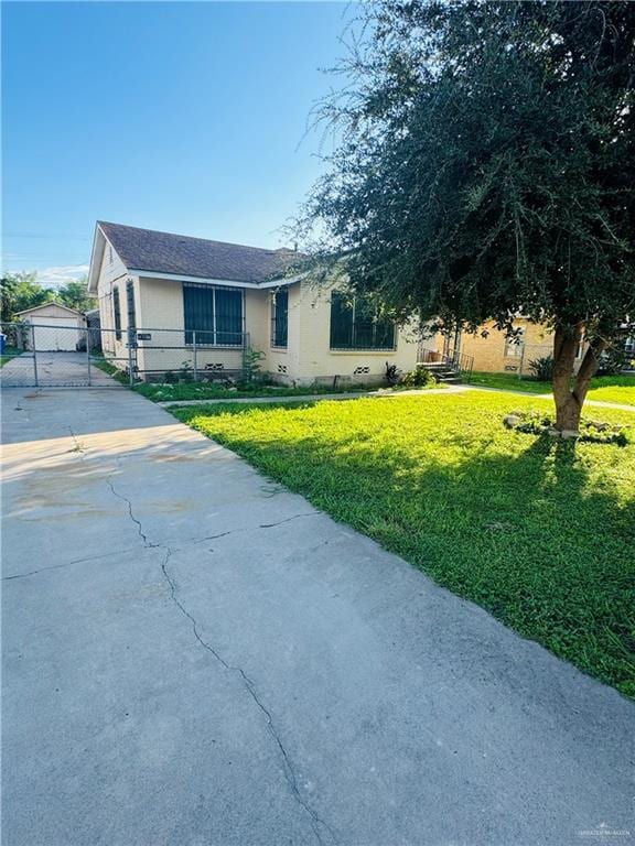 view of front of property with a front yard and a garage