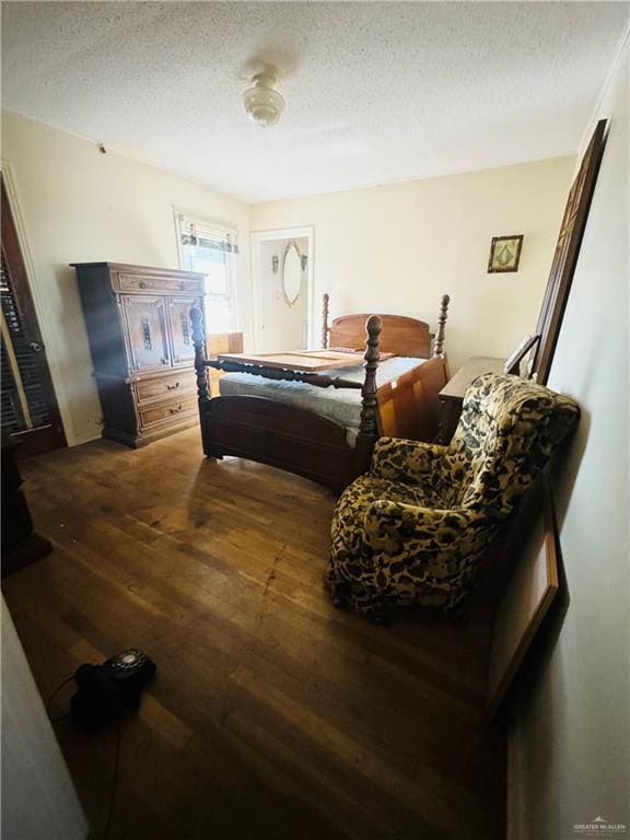 bedroom featuring hardwood / wood-style flooring and a textured ceiling