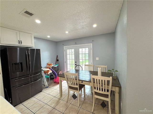 dining area with light tile patterned floors, visible vents, a textured ceiling, french doors, and recessed lighting