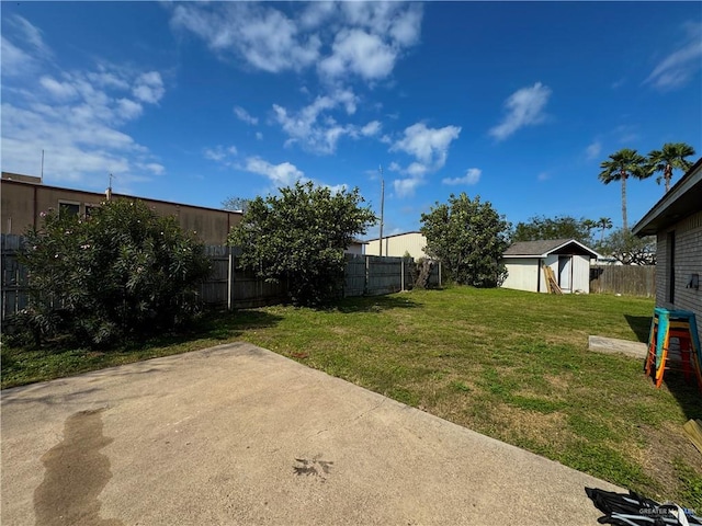 view of yard with an outbuilding, a patio, and a fenced backyard