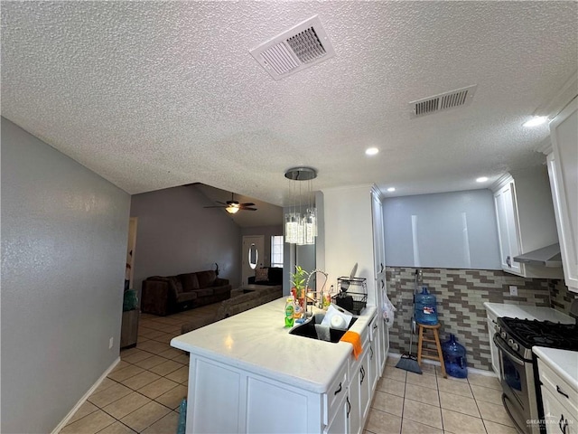 kitchen featuring light tile patterned floors, visible vents, light countertops, and stainless steel range with gas stovetop