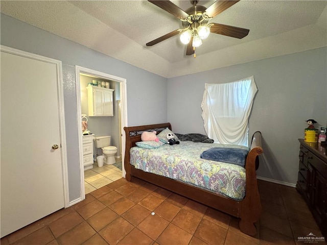 tiled bedroom featuring a textured ceiling, ceiling fan, vaulted ceiling, and connected bathroom