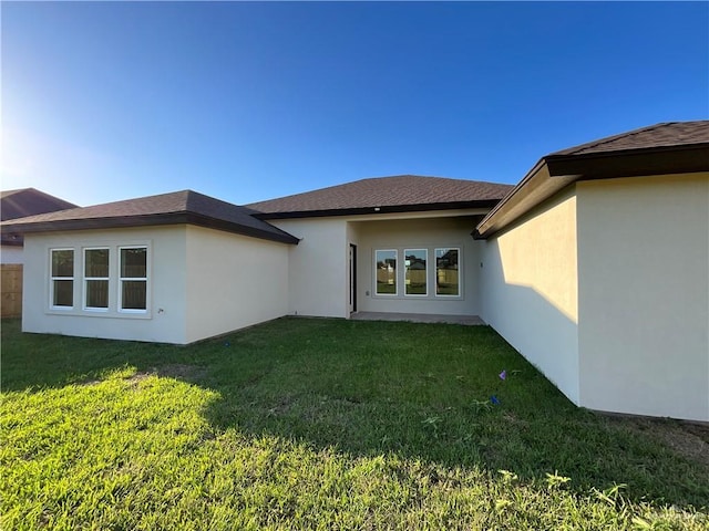 1513 Helen Dr, Weslaco, TX 78596 - back of house with a yard, stucco siding, and a shingled roof