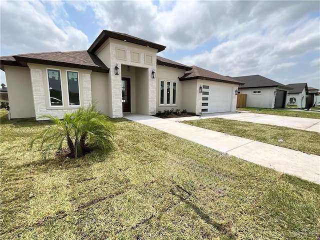 1513 Helen Dr, Weslaco, TX 78596 - prairie-style home with driveway, a front yard, an attached garage, stone siding, and stucco siding