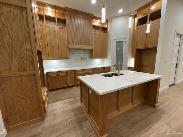 1513 Helen Dr, Weslaco, TX 78596 - kitchen with open shelves, a sink, brown cabinetry, an island with sink, and tasteful backsplash