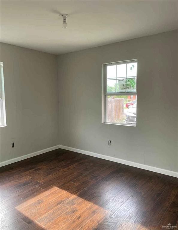 2708 Hackberry St, Weslaco, TX 78596 - unfurnished room with baseboards and dark wood-style floors
