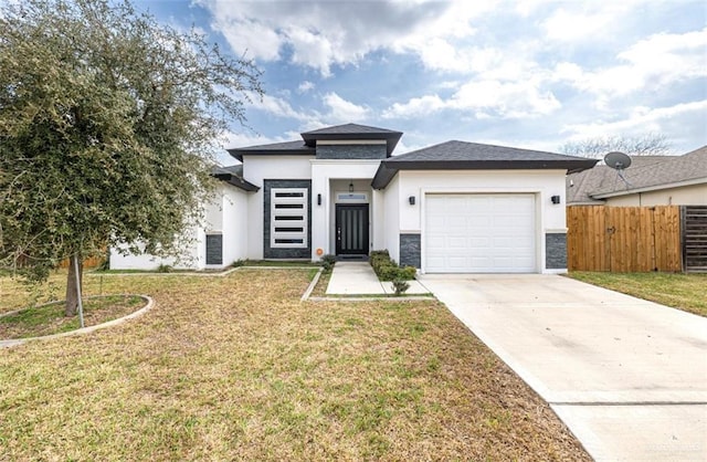 prairie-style home with a garage, concrete driveway, a front lawn, and stucco siding