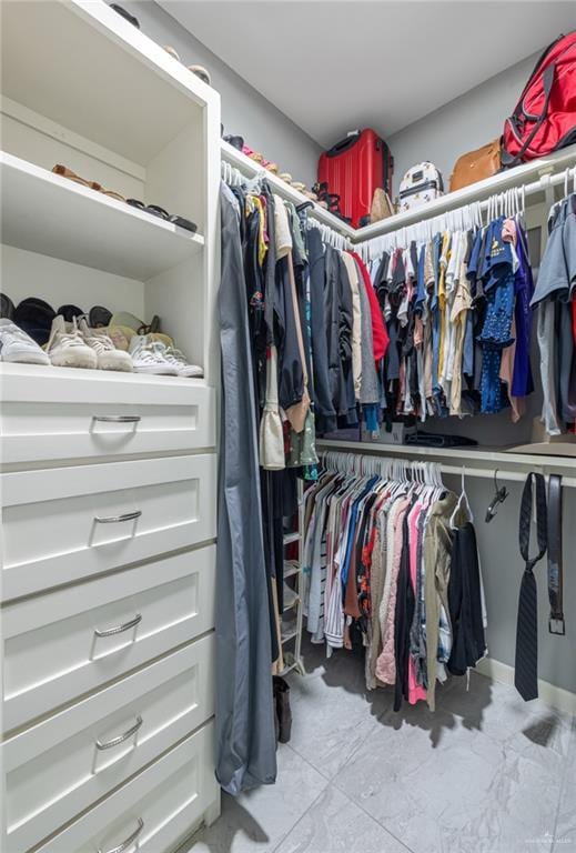 spacious closet with marble finish floor