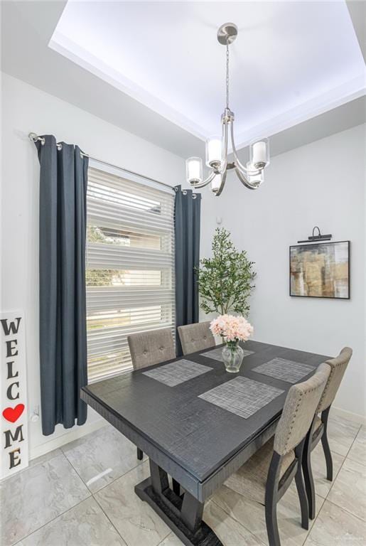 dining space with a chandelier, marble finish floor, and baseboards