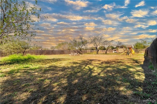 yard at dusk with a playground