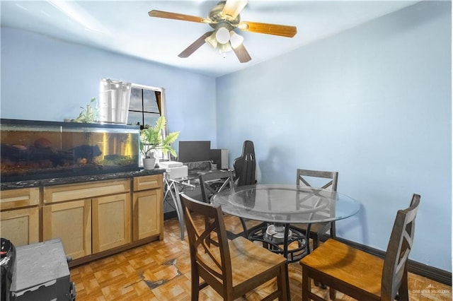 dining area with ceiling fan and light parquet flooring