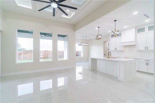 1608 Diplomat Dr, Edinburg, TX 78542 - kitchen with a ceiling fan, custom exhaust hood, white cabinetry, a sink, and recessed lighting