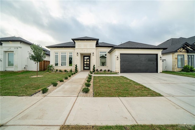 1608 Diplomat Dr, Edinburg, TX 78542 - prairie-style house featuring an attached garage, a front lawn, concrete driveway, and stucco siding