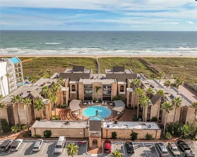 aerial view with a water view and a beach view