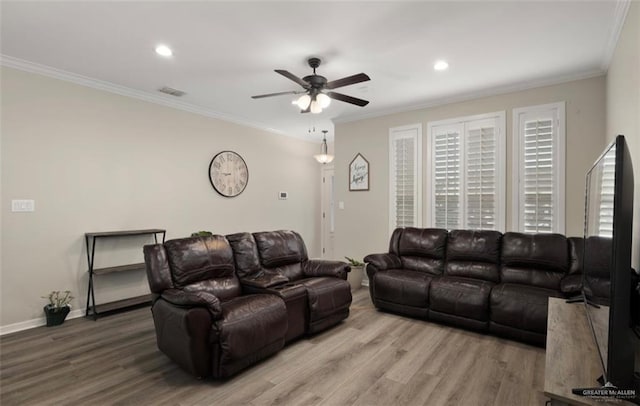 living room with ceiling fan, ornamental molding, and wood-type flooring