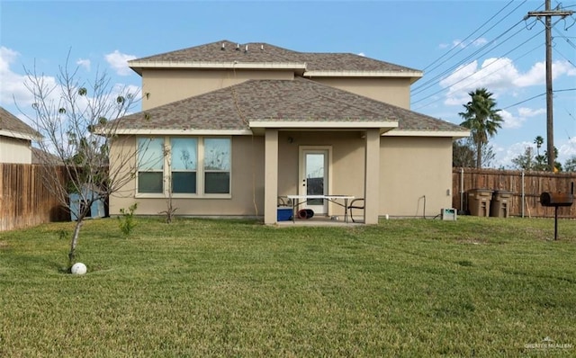 back of property featuring a patio area and a lawn