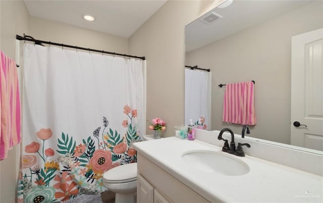 bathroom with toilet and vanity