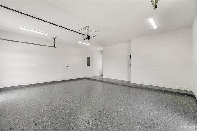 4916 N 26th St, Mcallen, TX 78504 - garage featuring a garage door opener, electric panel, and baseboards