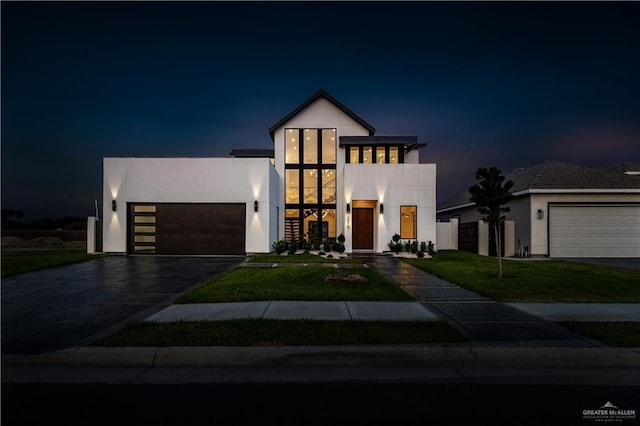 4916 N 26th St, Mcallen, TX 78504 - contemporary house with an attached garage, stucco siding, asphalt driveway, and a lawn