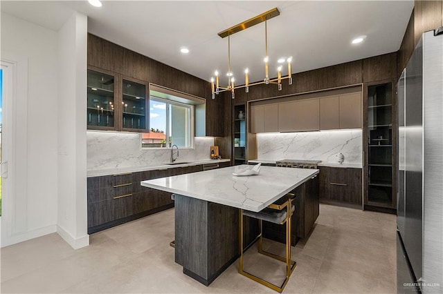 4916 N 26th St, Mcallen, TX 78504 - kitchen with modern cabinets, dark brown cabinets, a center island, glass insert cabinets, and recessed lighting