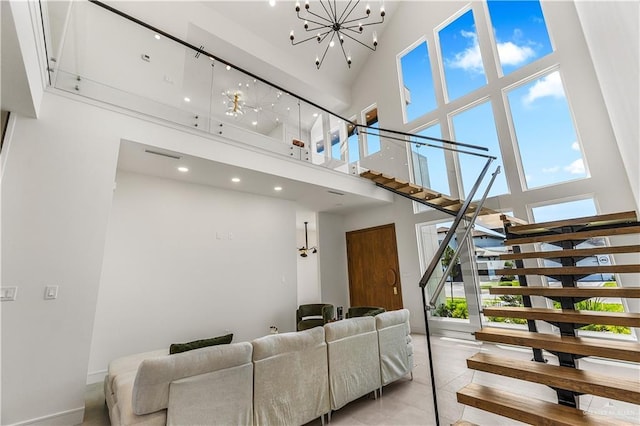 4916 N 26th St, Mcallen, TX 78504 - living room featuring a towering ceiling, stairs, a chandelier, healthy amount of natural light, and light tile patterned floors