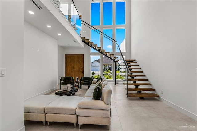 4916 N 26th St, Mcallen, TX 78504 - living room featuring a towering ceiling, stairway, baseboards, and recessed lighting