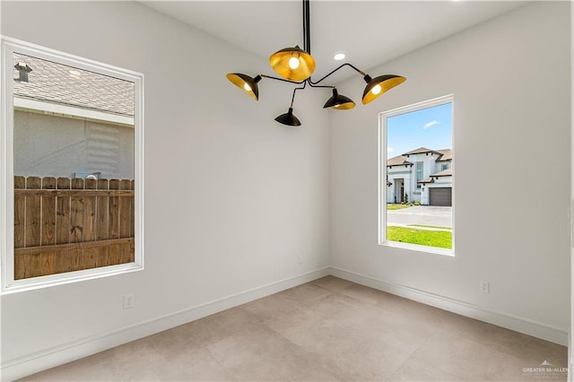 4916 N 26th St, Mcallen, TX 78504 - empty room with baseboards, a chandelier, and light tile patterned floors