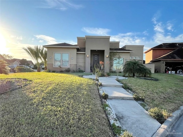 view of front of property with a front yard and stucco siding