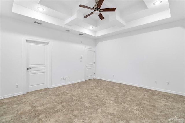 unfurnished room featuring a raised ceiling and ceiling fan