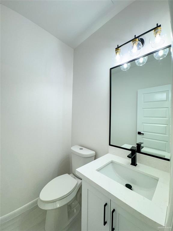 half bath with vanity and toilet