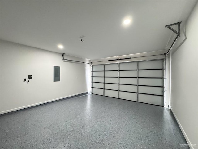 garage featuring baseboards, recessed lighting, and electric panel