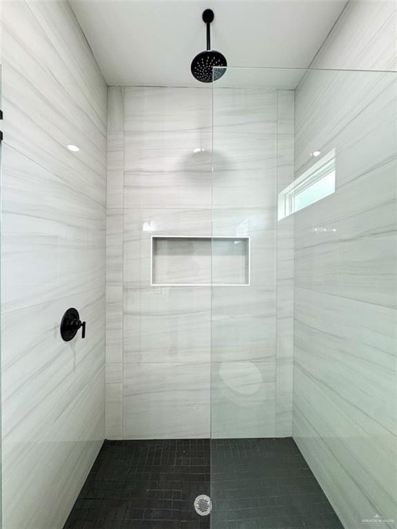 bathroom with a tile shower