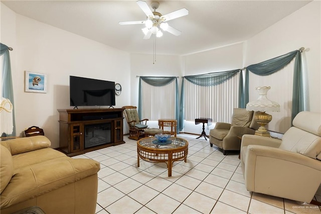 1923 Tyler St, Mission, TX 78572 - living room with light tile patterned flooring, a ceiling fan, and a glass covered fireplace
