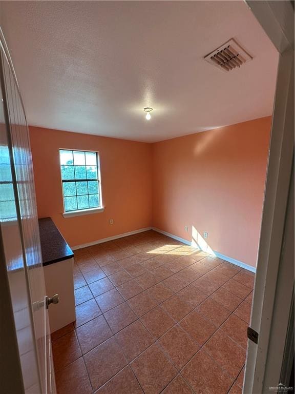 empty room featuring tile patterned flooring