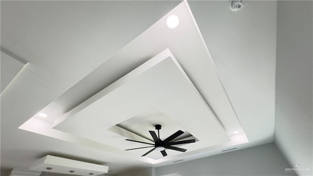 interior details with recessed lighting, a raised ceiling, and a ceiling fan